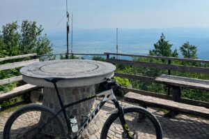Mountain bike at the Mt Krim viewpoint overlooking the landscape on a Slovenia mountain bike tour