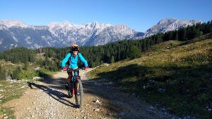 Mountain biker descending a rocky alpine trail on one of the top mountain biking trips in Slovenia, Europe