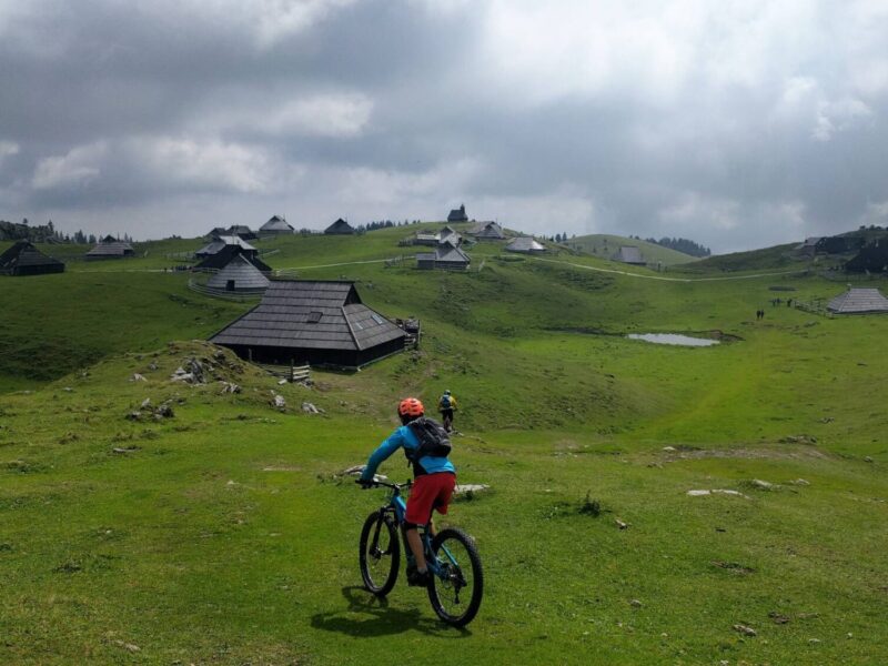 Mountain biker riding across Velika Planina on the Trans Slovenia 04 mountain bike tour