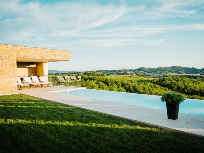 Hotel with pool and view of green hills