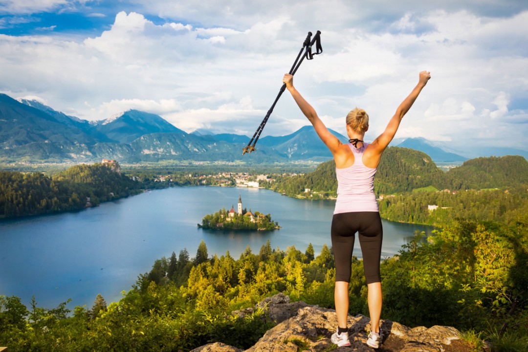 Hiker overlooking Lake Bled from a nearby hill on the Best of Slovenia Hiking Tour