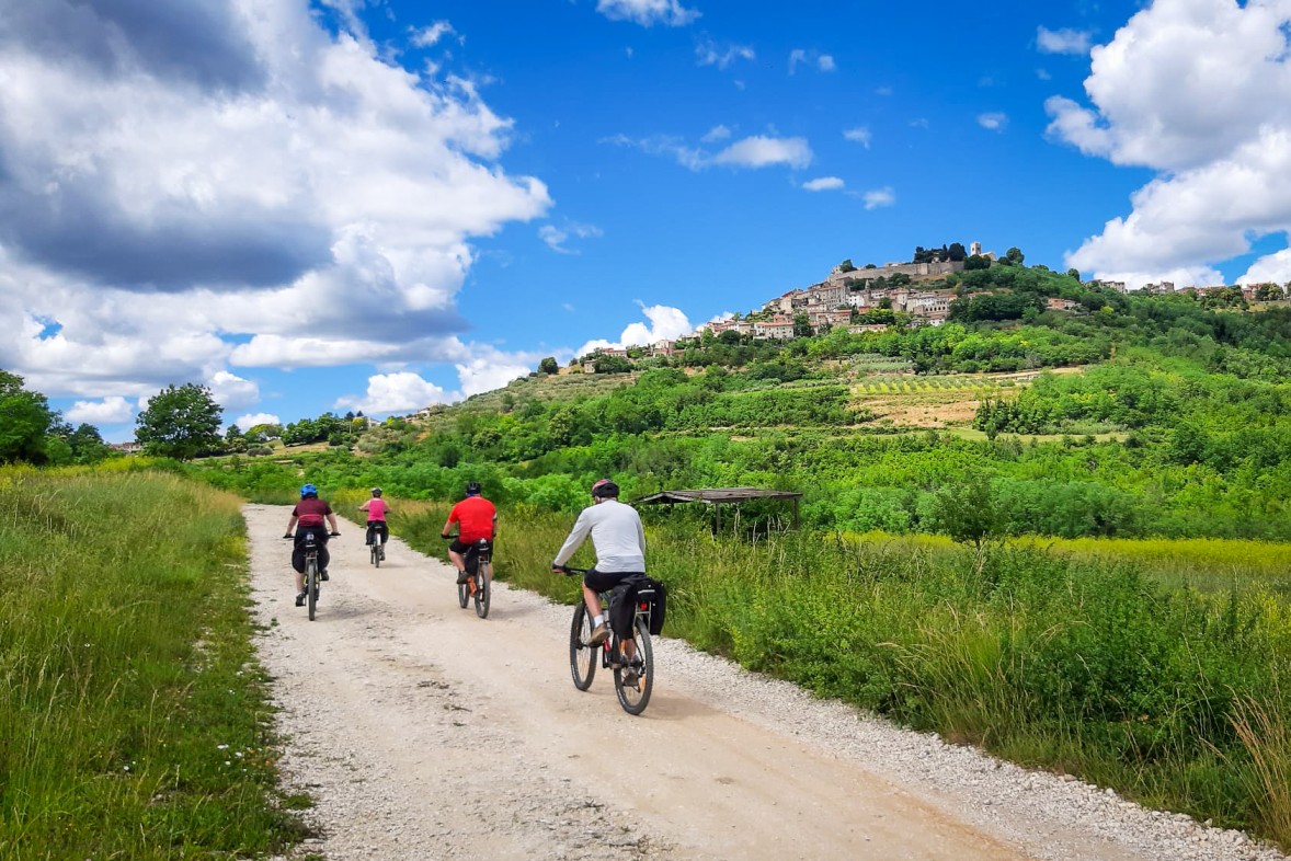 Cyclist on the Istria to the Adriatic Tour passing the Motovun town