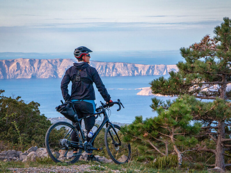 Cyclist enjoys view of Adriatic islands on Trans Dinarica Croatia gravel cycling tour
