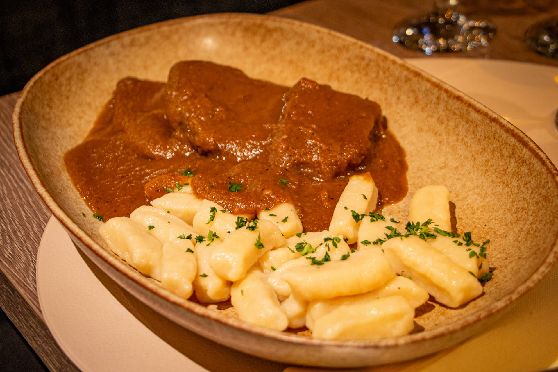 Traditional dinner in Sinj: gnocchi and steaks in sauce.