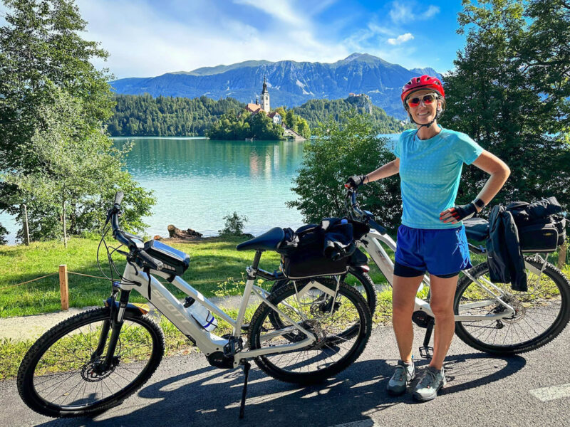 A female cyclist visiting Bled Lake on a cycling tour in Slovenia.