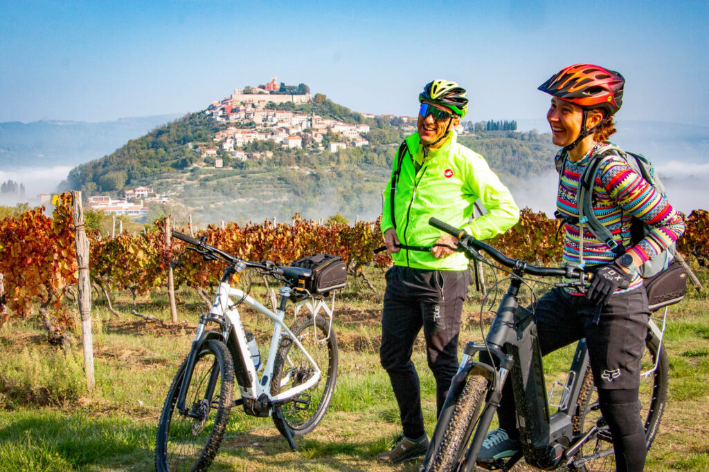 Two cyclists on e-bikes enjoying a bike tour in Istria, Croatia.