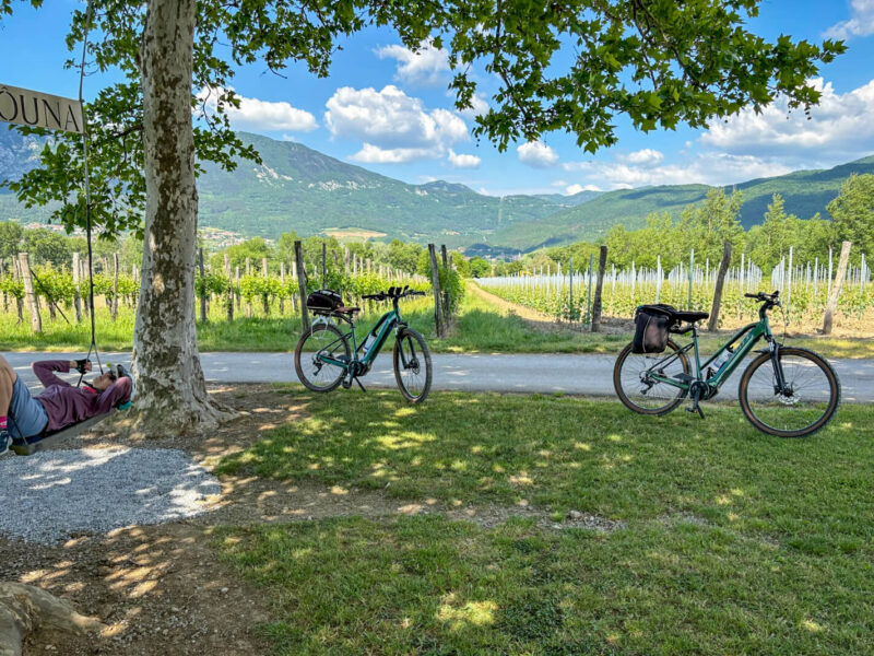 Two ladies on e-bikes cycling in Vipava Valley, Slovenia.