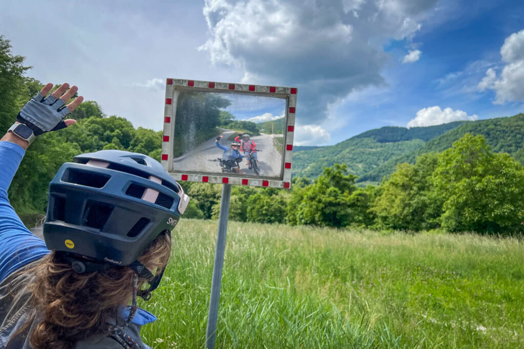 Two cyclists making a selfie in a mirror.