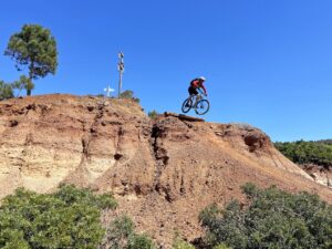 Mountain biker riding along a rocky singletrack trail on Elba Island, Italy