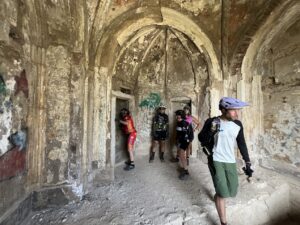 Bikers exploring the historic Tonietti Mausoleum during a mountain biking tour on Elba Island