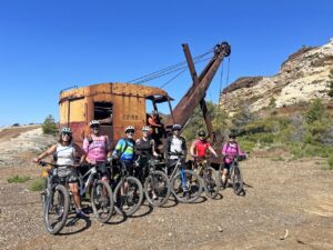 Group of mountain bikers with their bikes at the abandoned Vallone mine on Elba’s MTB trails