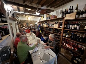 Tour group enjoying a wine tasting in a traditional wine cellar on Elba Island